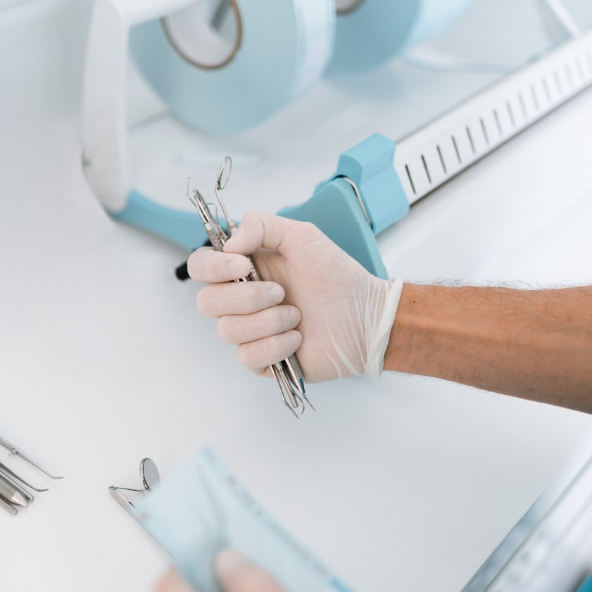 Dentist holding sterilized equipments in his hands | Kokua Smiles